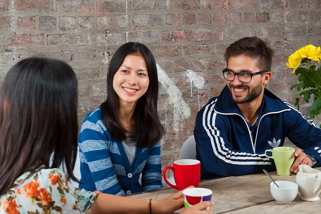 International students enjoying a conversation over coffee in a social area at ISI Dublin.