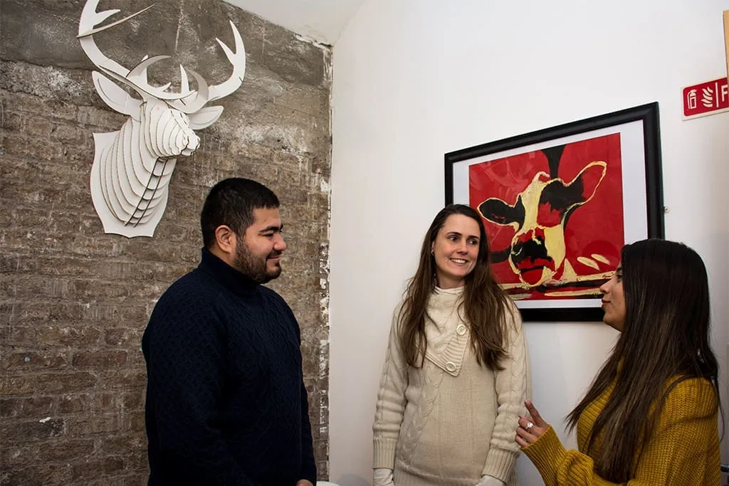 Students having a conversation in a social space at ISI Dublin, surrounded by modern school interiors.