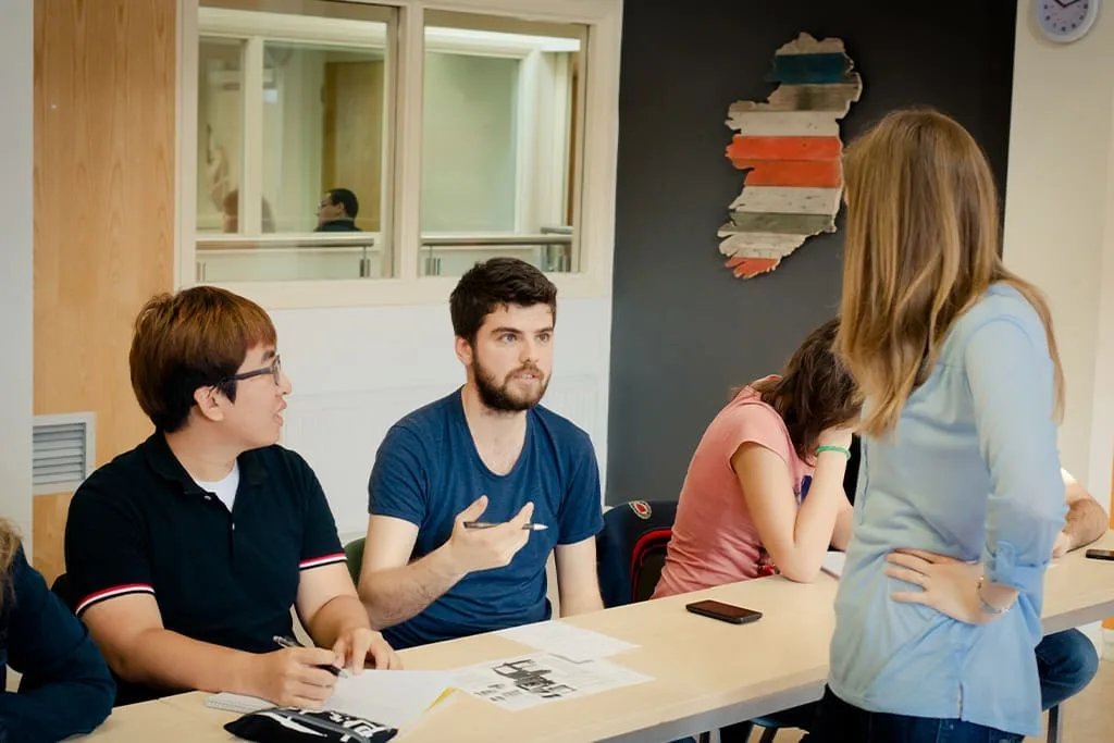 Students speaking with their teacher during an English class at ISI Dublin.